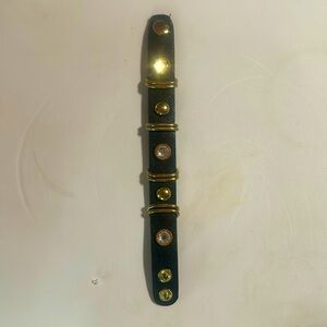 Black leather bracelet with gold rings, rhinestones or cubic zirconia with snaps